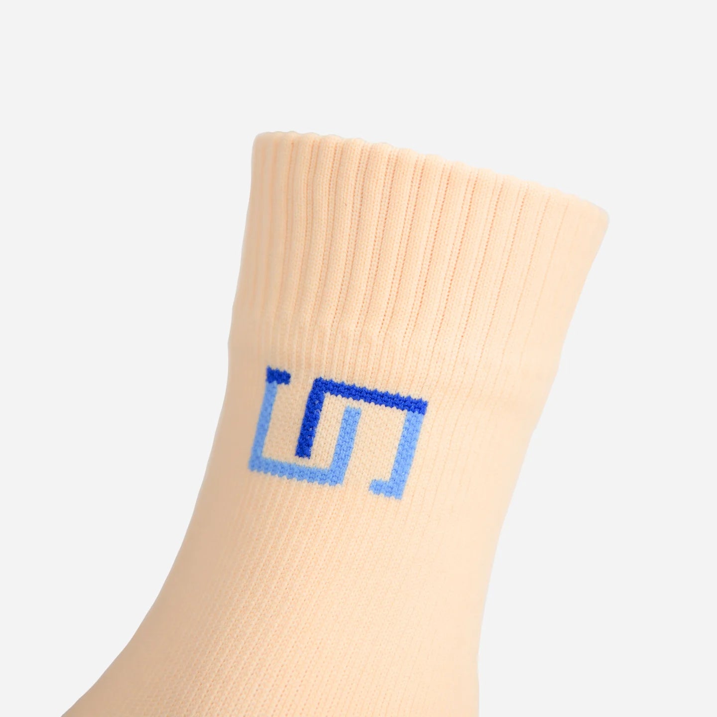 a close up view of logo on soft ivory sock