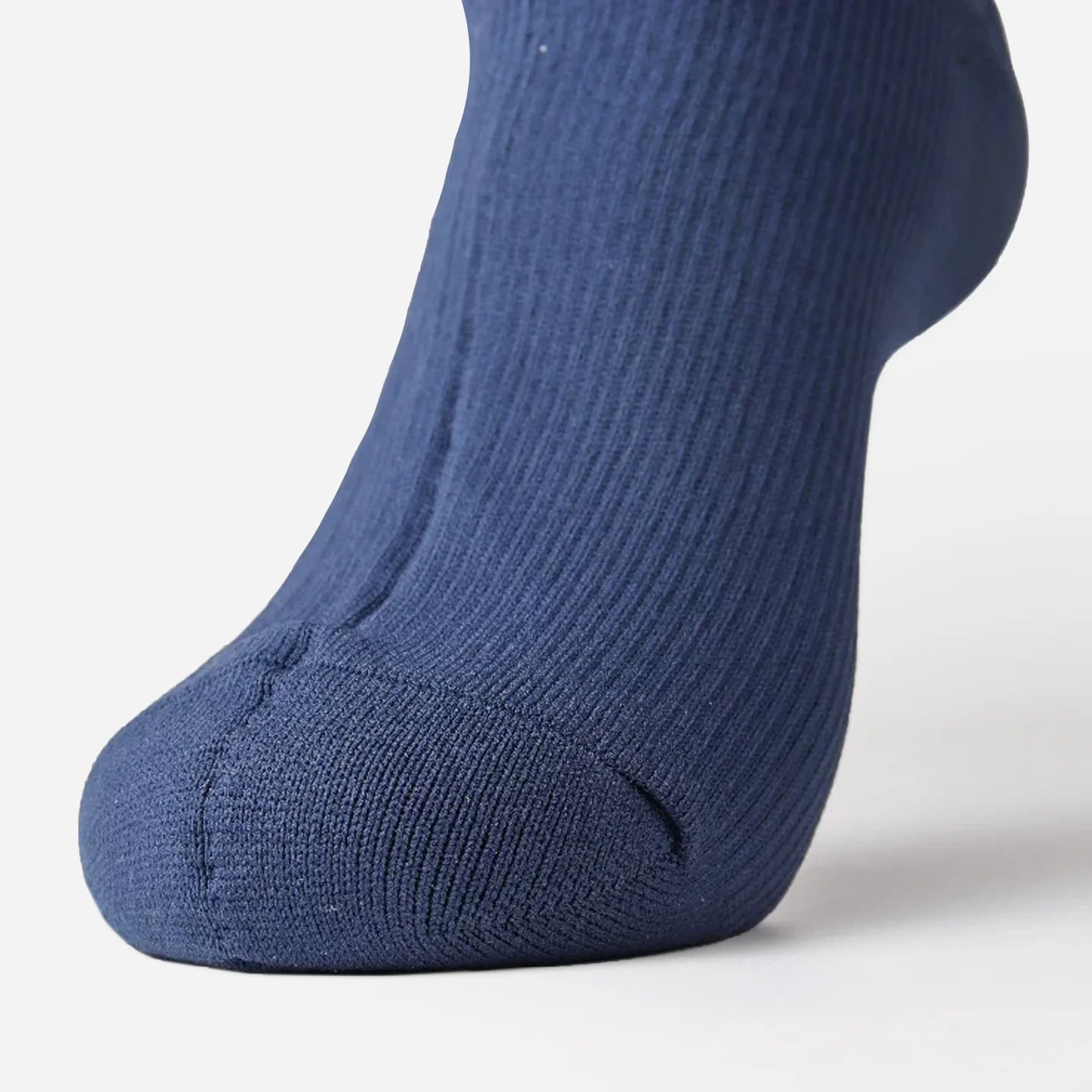 close-up of a navy blue sock on a foot from front