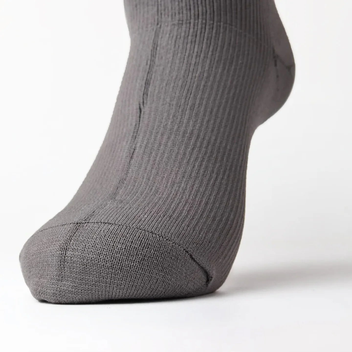 close-up of a stone grey sock on a foot from front