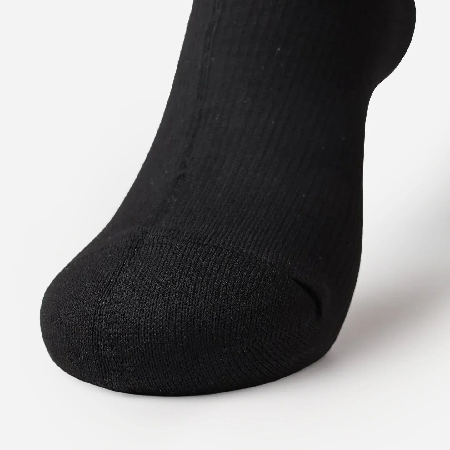 close-up of a black sock on a foot from front