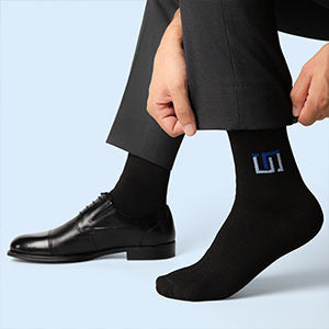 a man wearing jet black wudhu socks on his foot