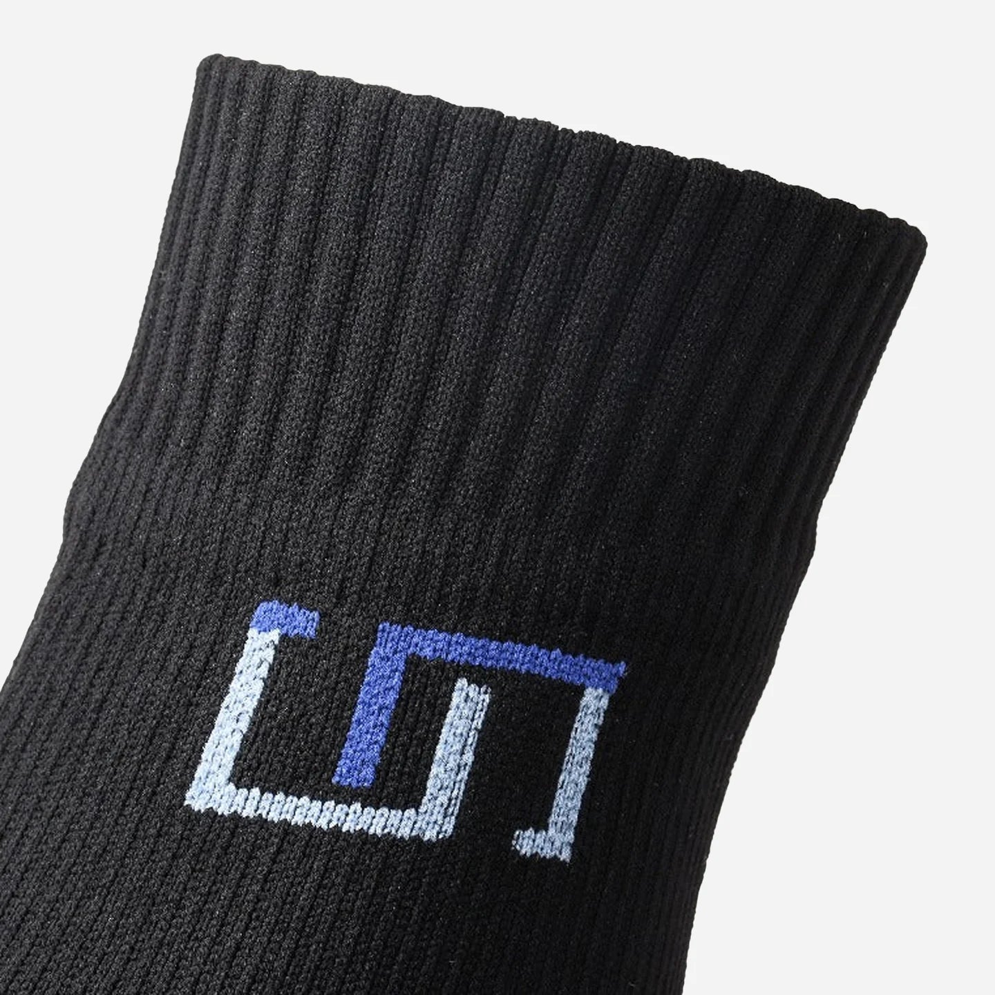 a close up view of logo on black sock