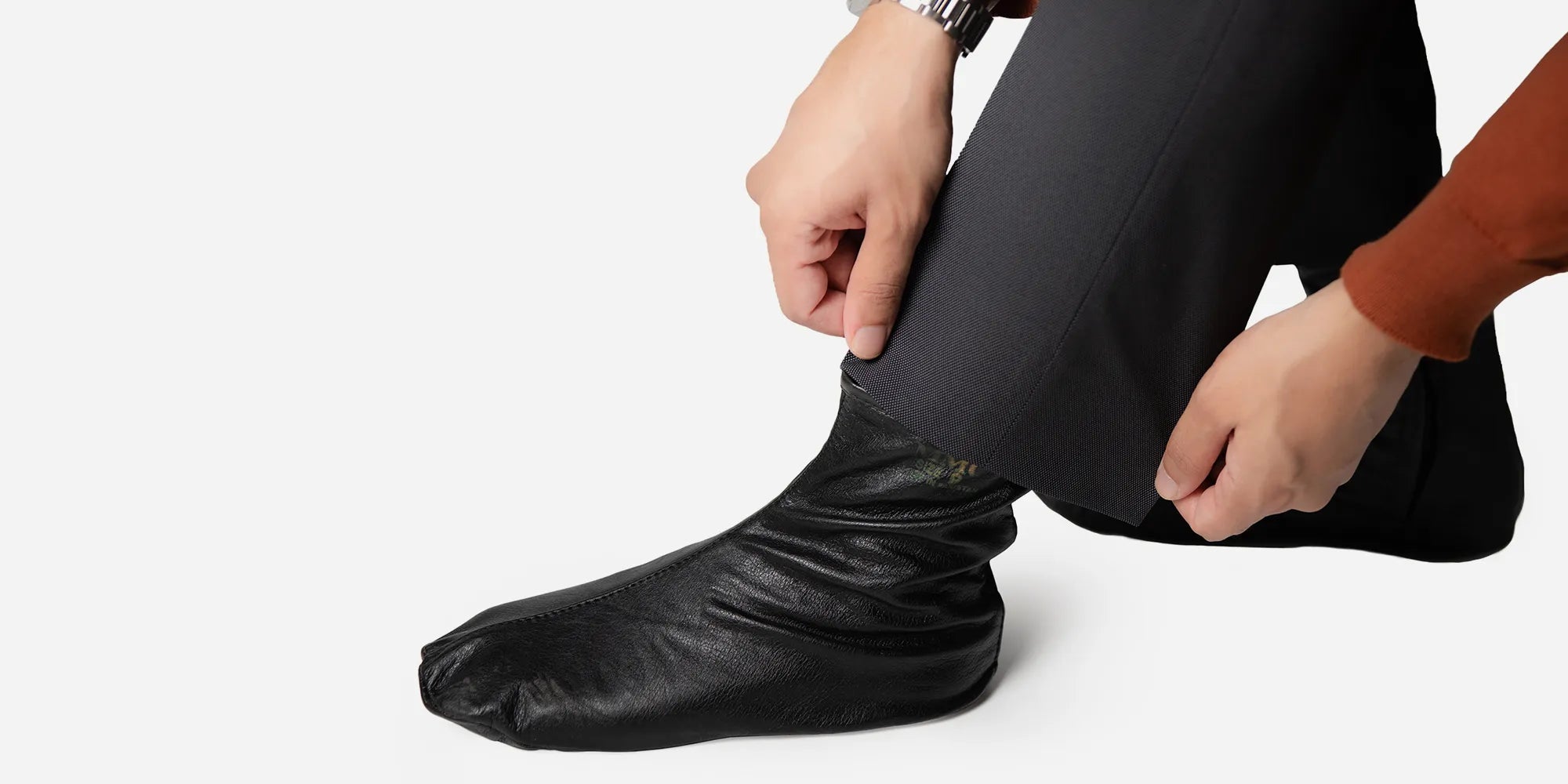 a man wearing leather socks in black color