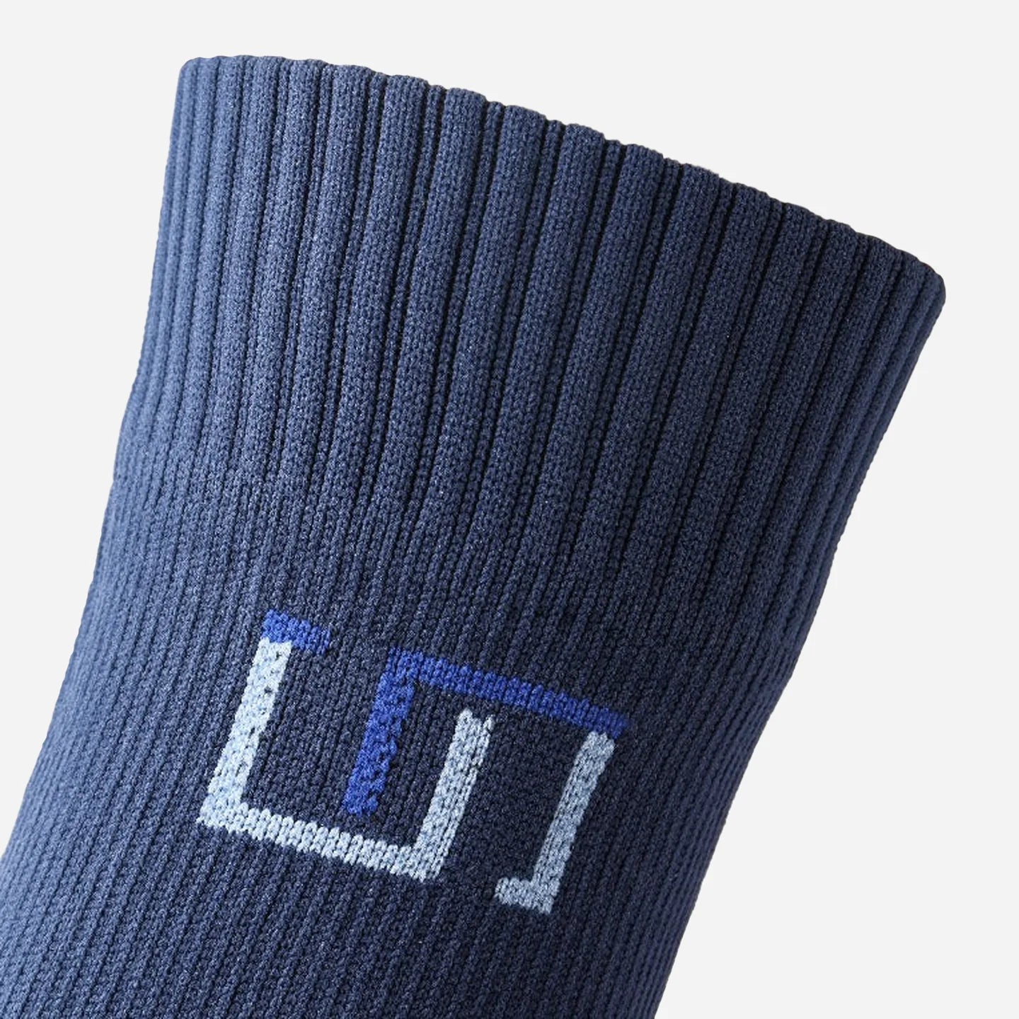 a close up view of logo on navy blue sock