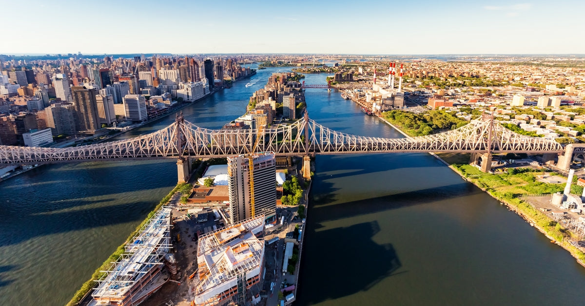 aerial view of the Queensboro Bridge spanning the East River in New York City, with Manhattan and surrounding buildings in the background