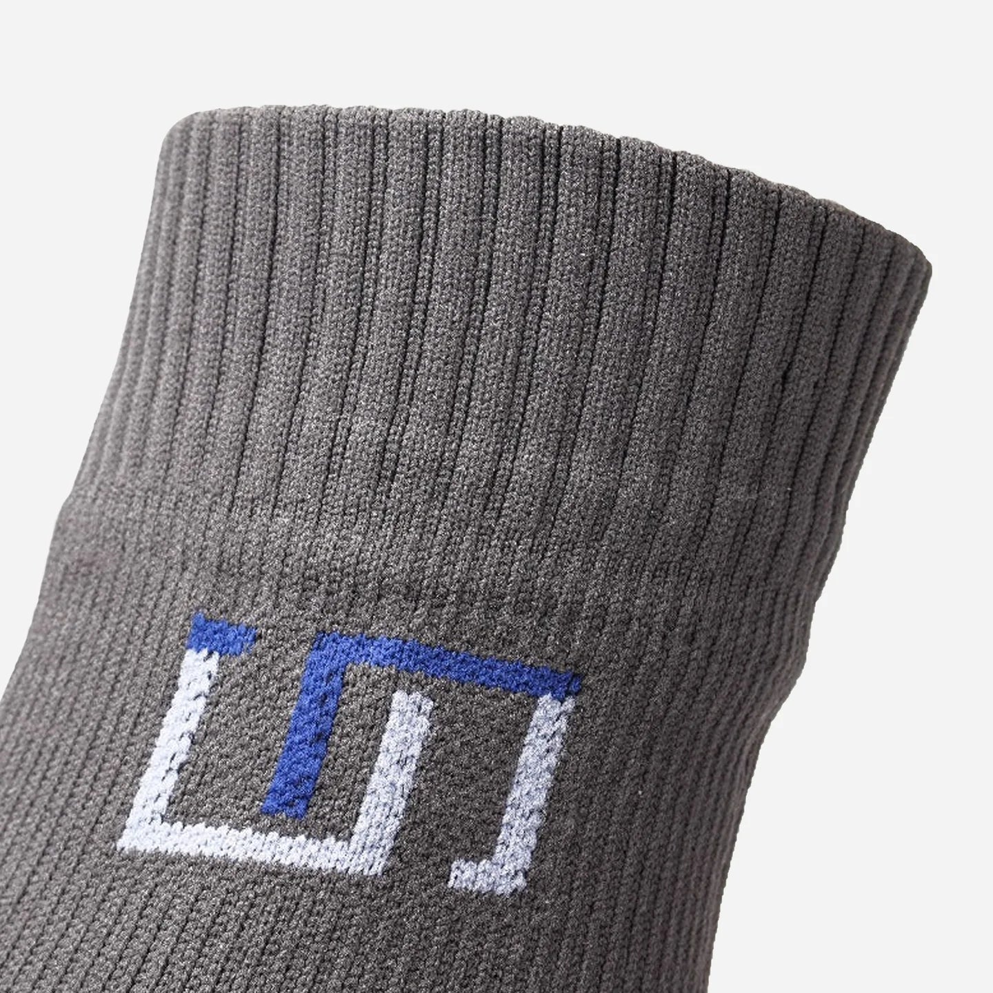 a close up view of logo on stone grey sock