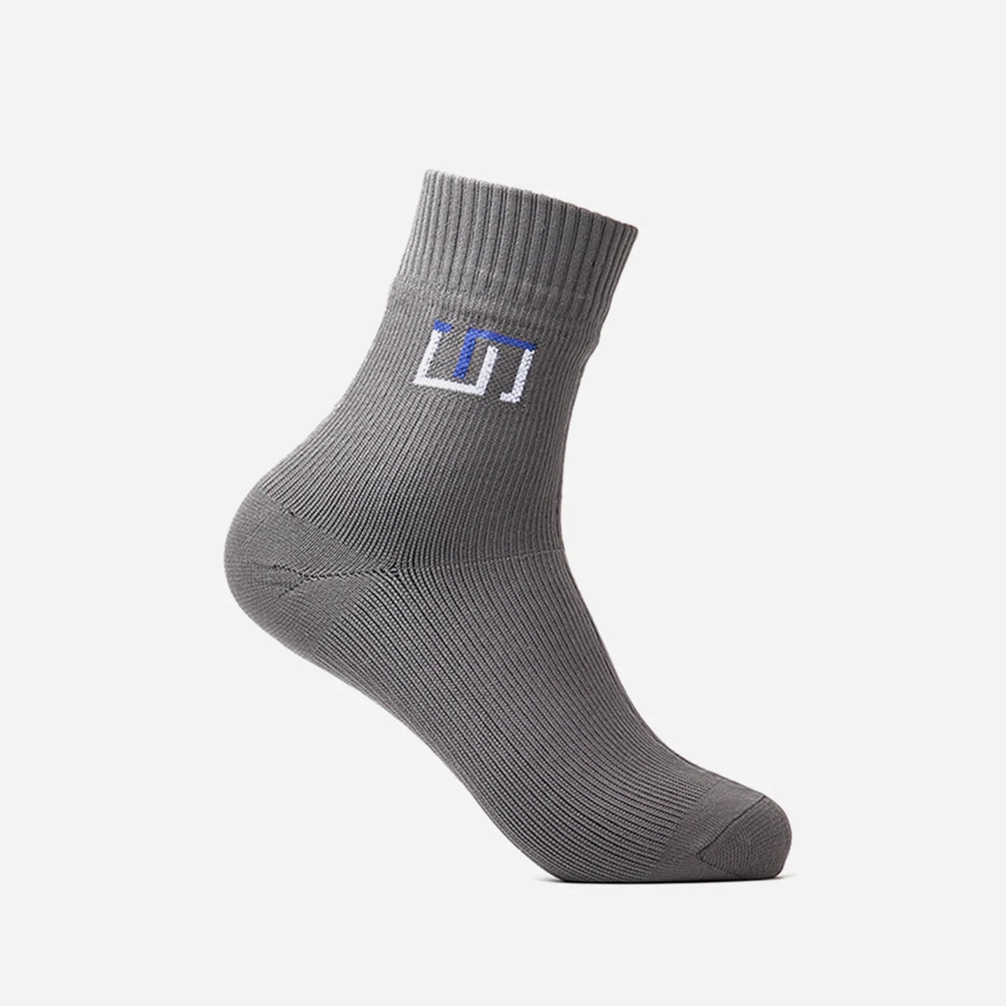a stone grey wudhu sock with The Wudhu Socks logo in blue on the upper part
