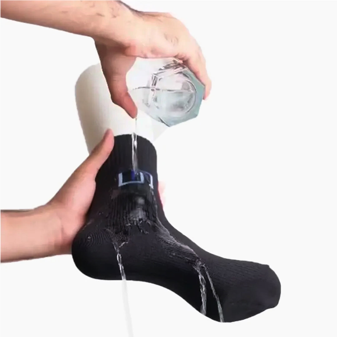A person dropping water on black waterproof wudhu sock