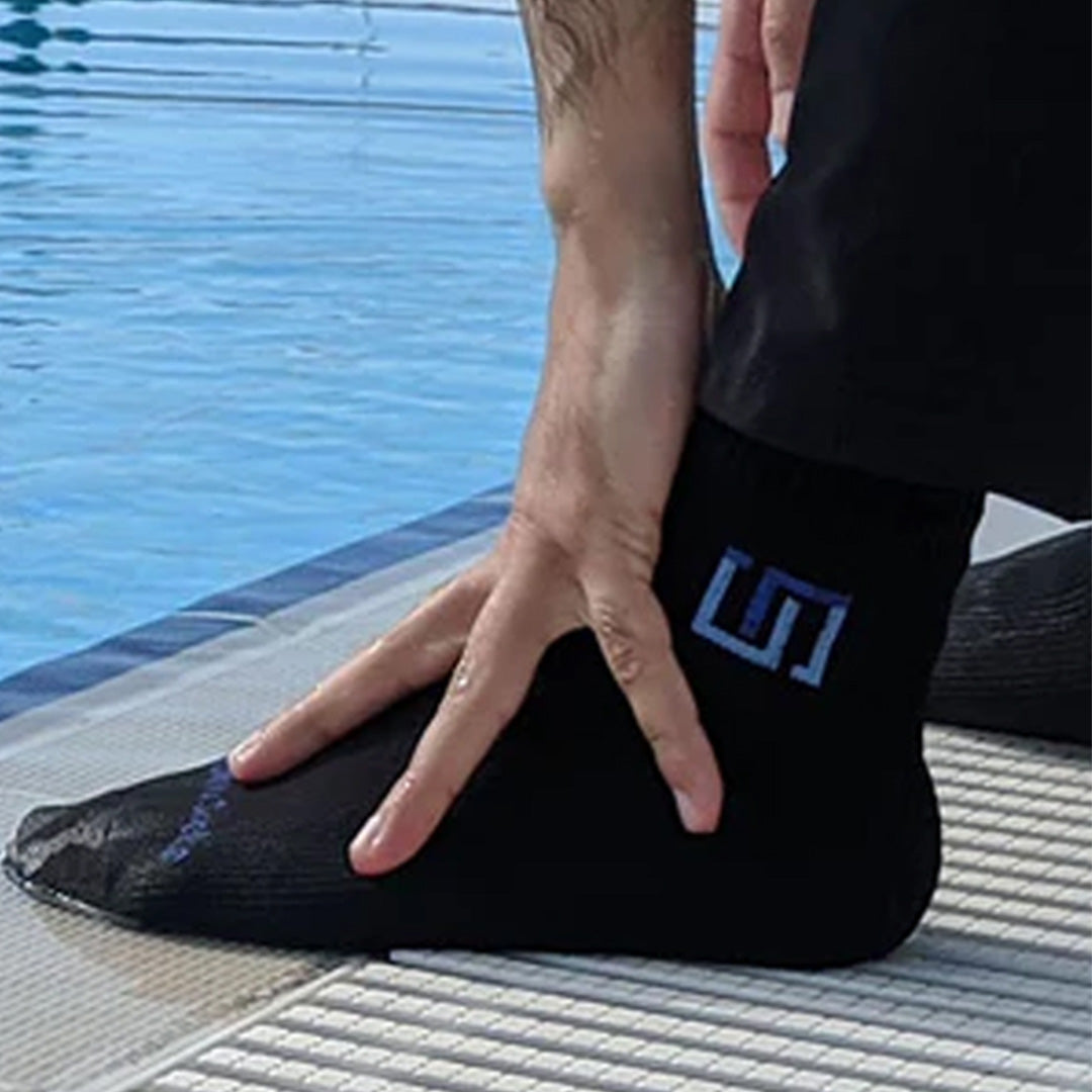 a man performing masah over the wudhu socks