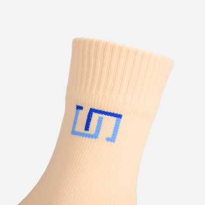 a close up view of logo on soft ivory sock