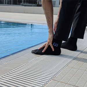 a man performing masah while wearing the waterproof wudhu socks