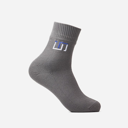 a stone grey wudhu sock with The Wudhu Socks logo in blue on the upper part